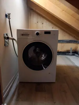 a washing machine sitting in a room with a wall at Mansarda Vale e Schena con vasca idromassaggio 4 posti letto a Cortina d'Ampezzo in San Vito di Cadore