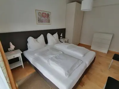 a large white bed in a small room at Apartment Mair in Valdaora