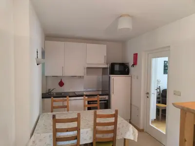 a kitchen with a table and chairs in a room at Apartment Mair in Valdaora