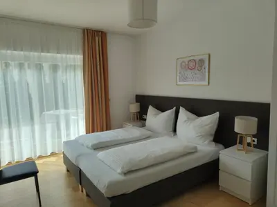 a bedroom with a large bed and a window at Apartment Mair in Valdaora