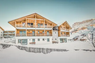 a house in the snow with a fence at Apt Bel Pre in La Villa
