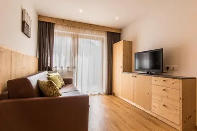 a living room with a couch and a flat screen tv at Apt Bel Pre in La Villa