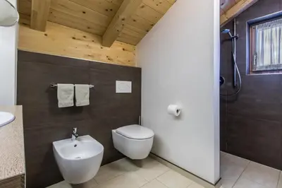 a bathroom with a white toilet and a sink at Apt Bel Pre in La Villa
