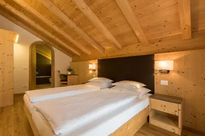 a large white bed in a room with wooden ceilings at Apt Bel Pre in La Villa