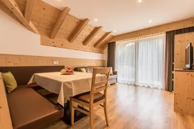 a dining room with a table and a couch at Apt Bel Pre in La Villa