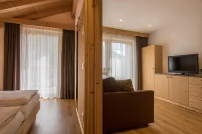 a hotel room with a couch and a television at Apt Bel Pre in La Villa