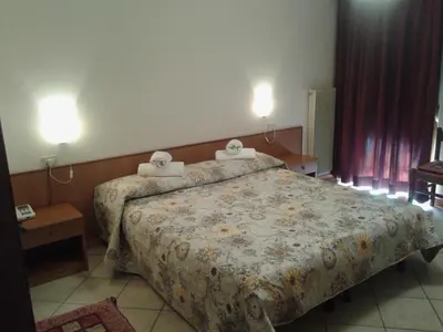 a hotel room with a bed with two towels on it at Hotel Salgetti in Mezzano