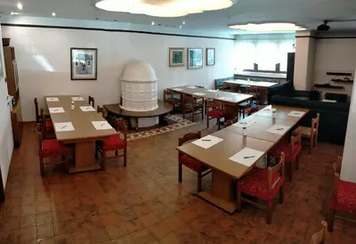 a restaurant with tables and chairs and a piano at Hotel Salgetti in Mezzano