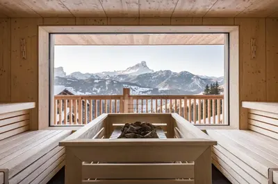 a sauna with a view of the mountains at Hotel Ciurnadú in La Valle