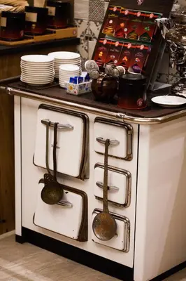 a kitchen with a stove with two spoons on it at Örtlerhof in Tirolo