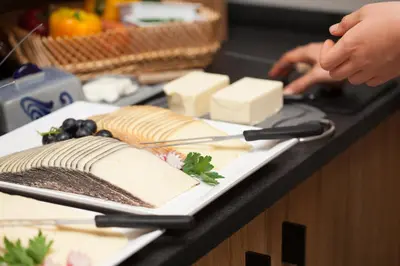 a plate of cheese and other foods on a counter at Örtlerhof in Tirolo