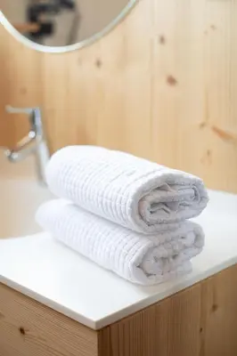 a stack of towels sitting on a bathroom counter at Örtlerhof in Tirolo