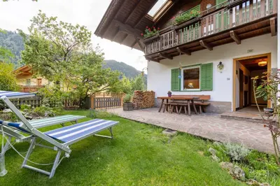 a patio of a house with a table and chairs at Haus Vieider in Collepietra