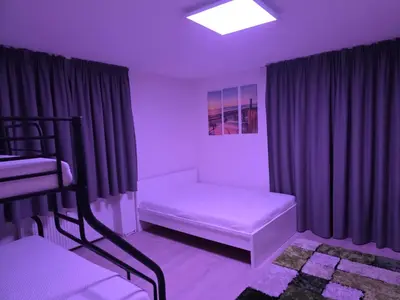 a purple room with a bunk bed and a bench at V91 Young People Citymountain in Brunico