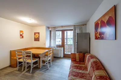 a living room with a table and a couch at Cesa de Piè in Canazei