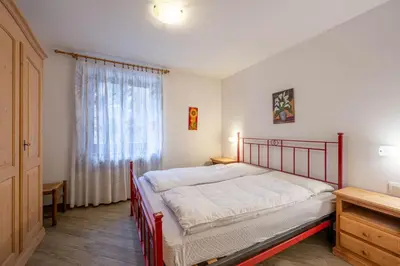 a bedroom with a bed and a window at Cesa de Piè in Canazei