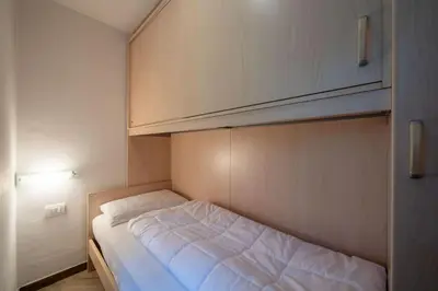 a small room with a bed in a room at Cesa de Piè in Canazei
