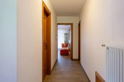 a hallway with a door and a room with a floor at Cesa de Piè in Canazei
