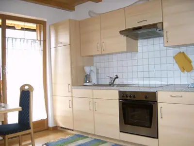 a kitchen with wooden cabinets and a stove top oven at Roanerhof in San Genesio Atesino