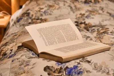 an open book sitting on top of a bed at Villa Antermont in Canazei