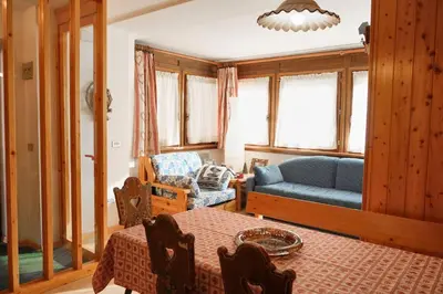 a living room with a couch and a table at Villa Antermont in Canazei