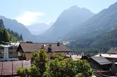 a view of a town with mountains in the background at Villa Antermont in Canazei