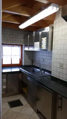 a kitchen with a sink and a counter top at Chalet Heidi in Arabba