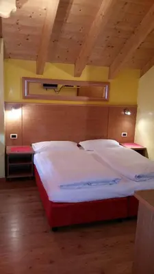 a bedroom with a large bed in a room at Chalet Heidi in Arabba