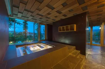 a large room with a hot tub with a large window at Kati`s Guesthouse-Zentral in Kaltern in Caldaro