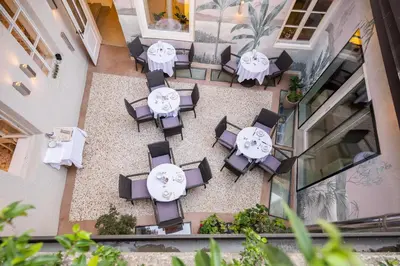 an overhead view of a restaurant with tables and chairs at Kati`s Guesthouse-Zentral in Kaltern in Caldaro