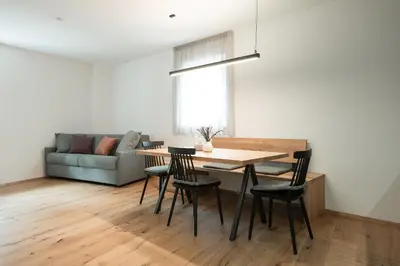 a living room with a table and chairs and a couch at Kati`s Guesthouse-Zentral in Kaltern in Caldaro