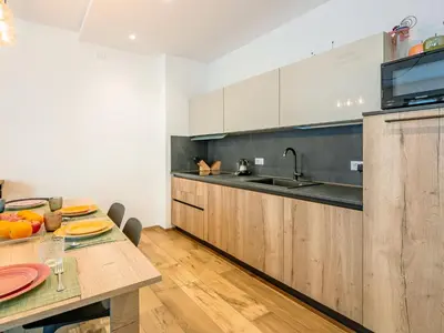 a kitchen and dining room with a table and chairs at Apartment Cesa del sass by Interhome in Alba di Canazei