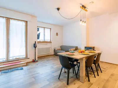 a living room with a table and chairs and a couch at Apartment Cesa del sass by Interhome in Alba di Canazei
