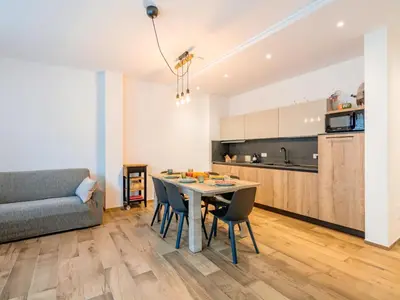 a kitchen with a large wooden table with oranges on it at Apartment Cesa del sass by Interhome in Alba di Canazei