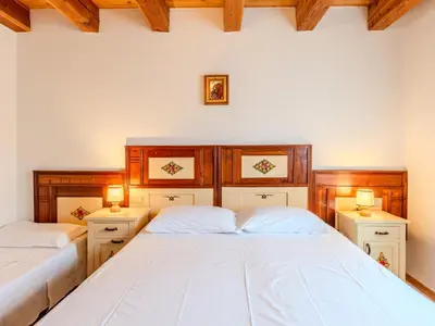 two beds in a bedroom with two lamps on the sides at Apartment Vento Alpino-4 by Interhome in Predaia