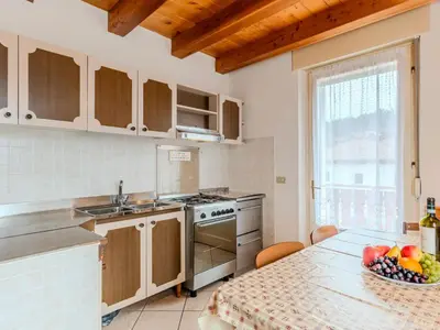 a kitchen with a table with a bowl of fruit on it at Apartment Vento Alpino-4 by Interhome in Predaia