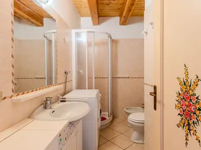 a bathroom with a sink and a toilet at Apartment Vento Alpino-4 by Interhome in Predaia
