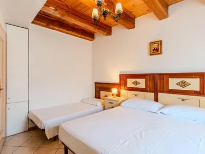 two beds in a room with wooden ceilings at Apartment Vento Alpino-4 by Interhome in Predaia