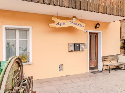 a building with a sign on the side of it at Apartment Vento Alpino-1 by Interhome in Predaia