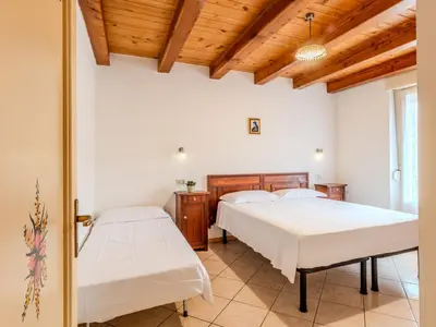 a bedroom with two beds and a wooden ceiling at Apartment Vento Alpino-1 by Interhome in Predaia