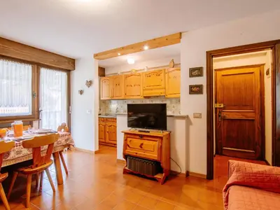 a kitchen with a table and a dining room at Apartment Apt 18 by Interhome in Campitello di Fassa