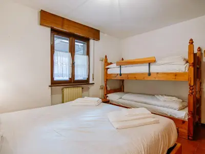 a bedroom with two bunk beds and a window at Apartment Apt 18 by Interhome in Campitello di Fassa
