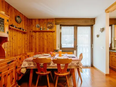 a kitchen with a table with chairs and a television at Apartment Apt 18 by Interhome in Campitello di Fassa