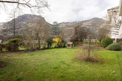 a yard with a small house in the grass at Apartment Vicolo Sabbia in Bolzano