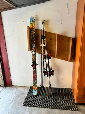 a snowboard and skis are hanging on a wall at Appartamento Fontanive in Masarè