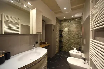 a bathroom with a sink and a toilet and a mirror at Appartamento Fontanive in Masarè