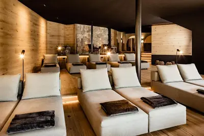 a living room with white couches and tables at Taubers Bio Vitalhotel in Chienes