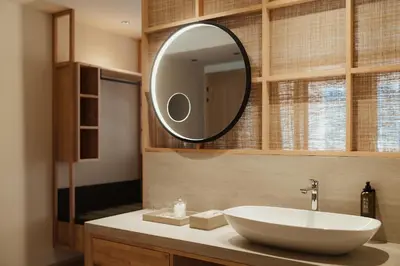 a bathroom with a white sink and a mirror at Taubers Bio Vitalhotel in Chienes