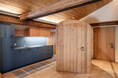a kitchen with a wooden door in a room at OBERBUCHFELDER historic farmhouse in Laion
