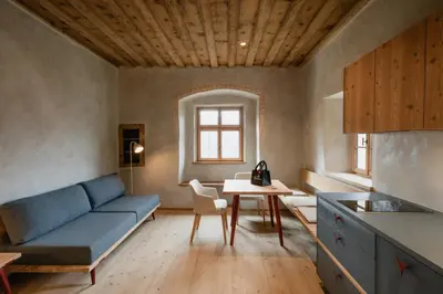 a living room with a blue couch and a table at OBERBUCHFELDER historic farmhouse in Laion